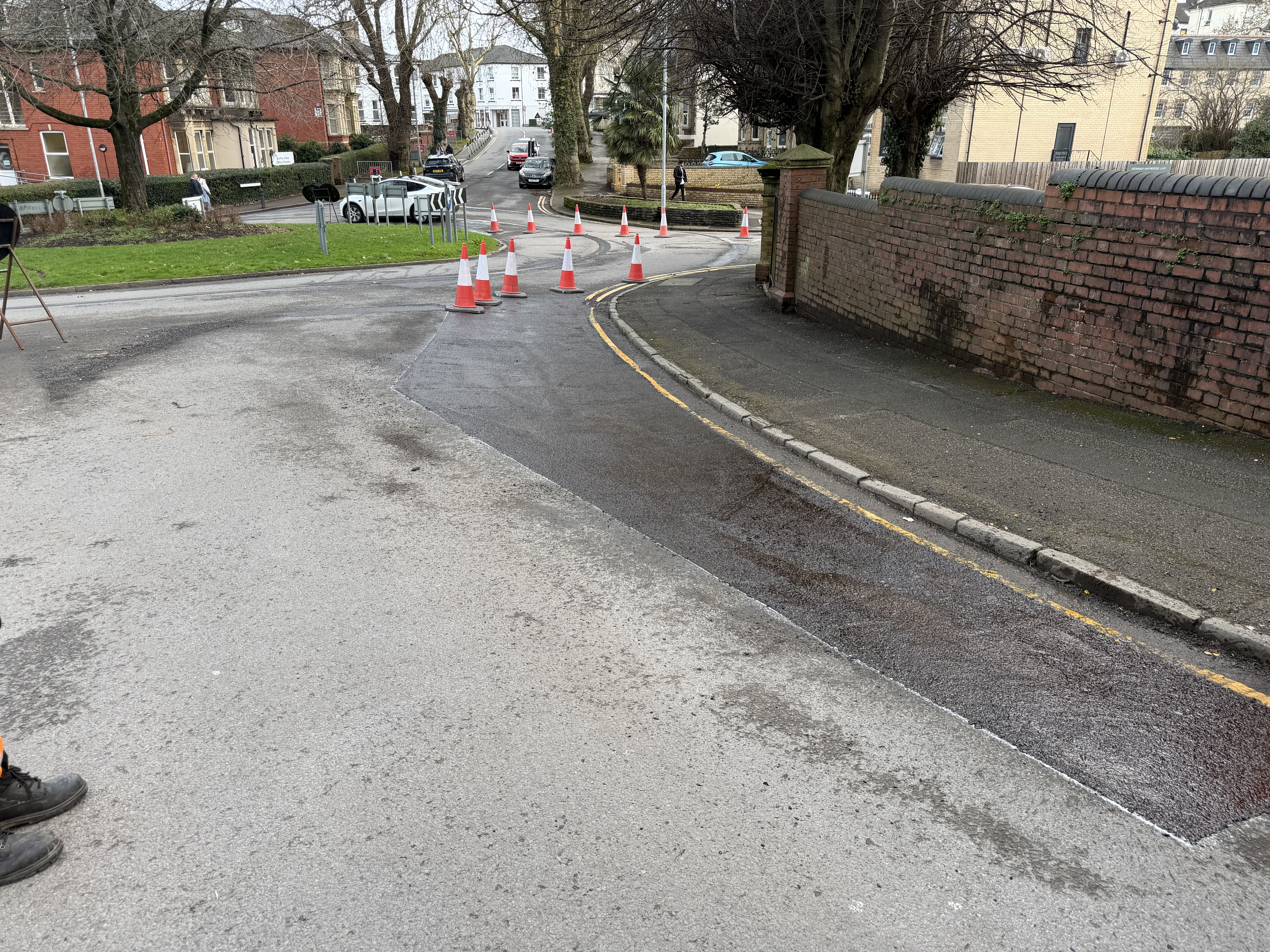 Completed thermoplastic road markings showing crisp white lines with excellent retroreflective properties alongside professionally installed road studs